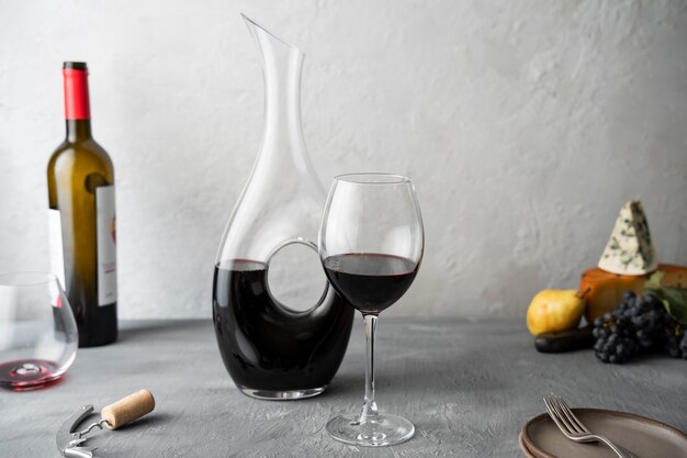 Decanter and red wine glass on table