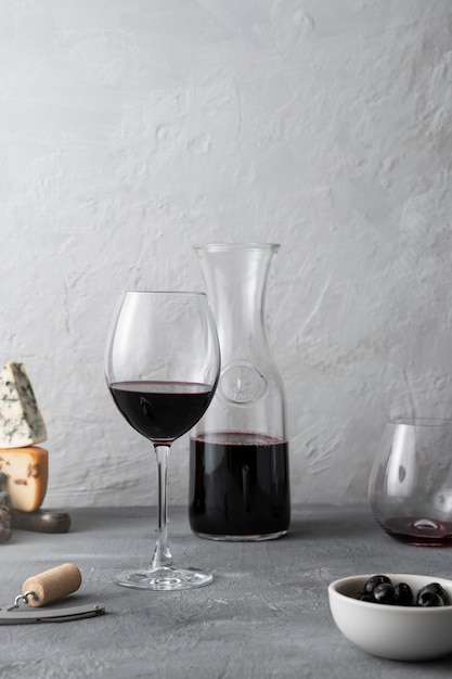 Decanter and red wine glass on table