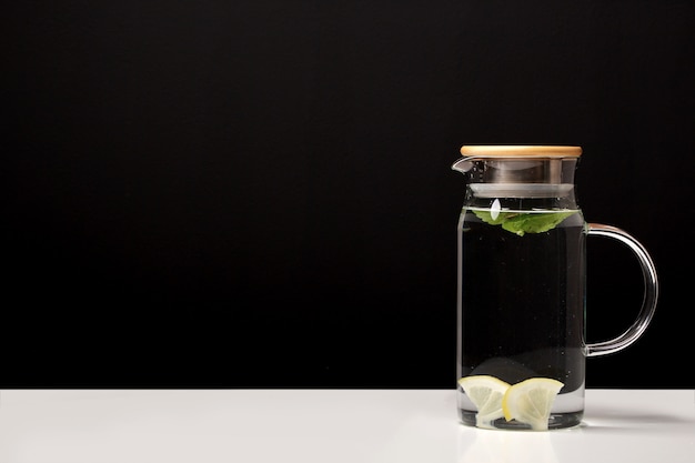 decanter with clean cool water with lemon and mint