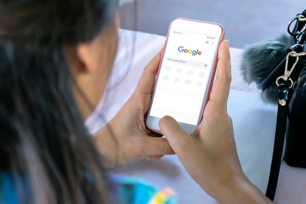 December 31 2019 Bangkok Thailand Asian woman is typing on Google search engine from a smartphone Google is the biggest Internet search engine in the world