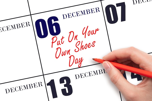 Photo december 6th hand writing text put on your own shoes day on calendar date save the date