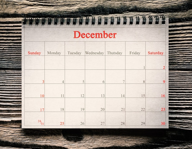 December in de kalender op de houten achtergrond