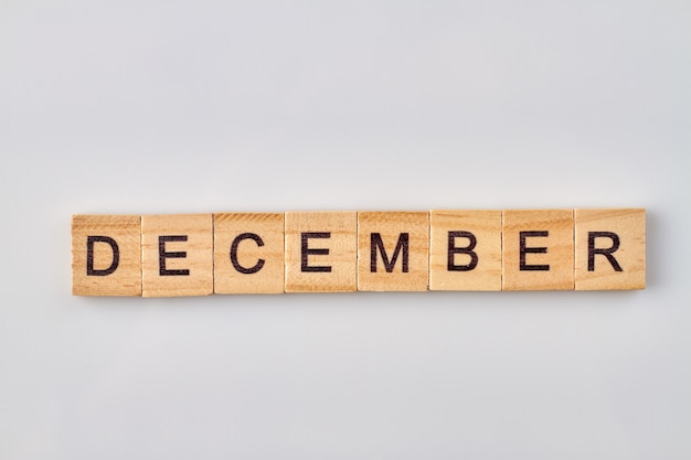 December word written on wooden blocks. Isolated on white background.