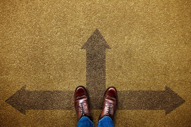 Photo decision in life or business concept. undecided person standing on the forward, left and right arrow direction. top view