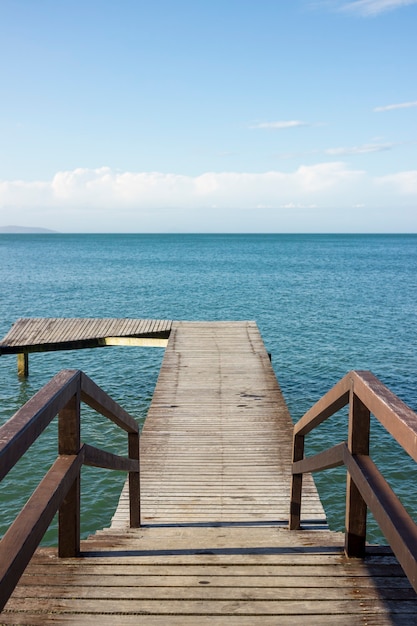 Deck on the beach with a beautifull landscape view of the ocean and nature. Blue sky