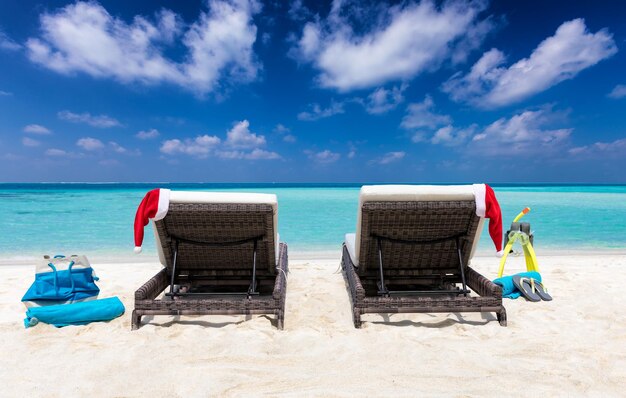 Deck chairs on beach against blue sky