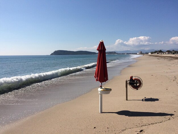 Deck chairs on beach against clear sky