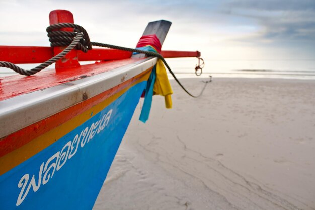 Deck chairs on beach against sky