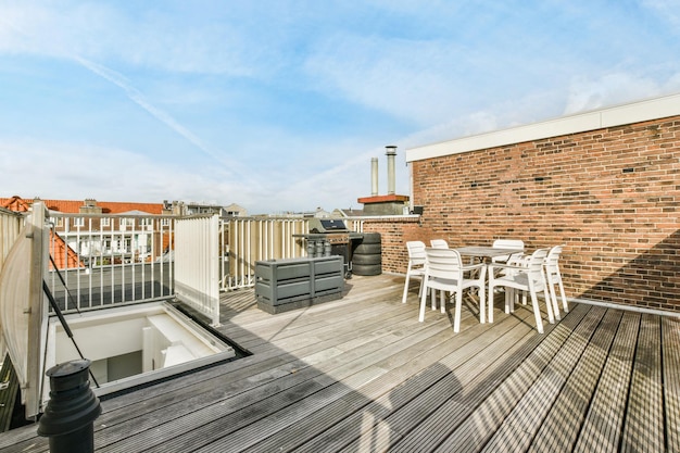 The deck has a table and chairs and a barbecue