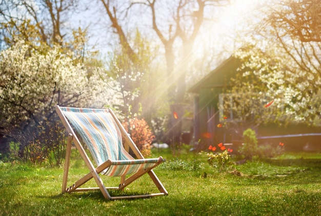 Photo deckchair on a background of a rural house in the summer