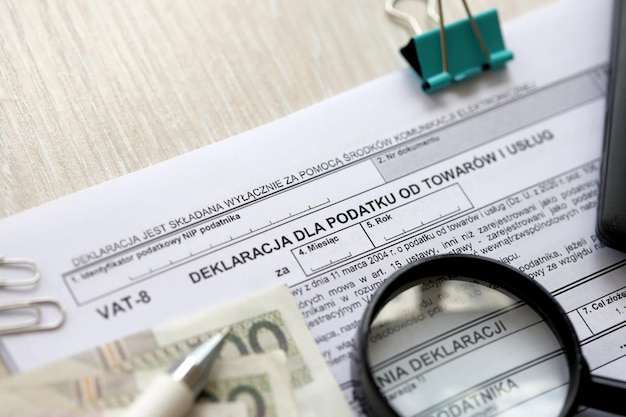 Declaration for tax on goods and services vat form on accountant table with pen and polish zloty