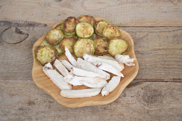 Declicious Zucchini and sliced meat in a wooden plate