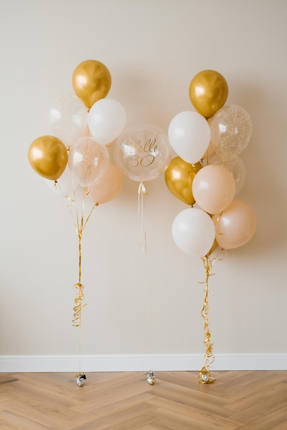 Decor for the celebration of the 30th anniversary Balloons of gold and white color