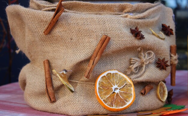 Decor for a jar for gluhwein from burlap with dried citrus fruit cinnamon sticks and dried anise