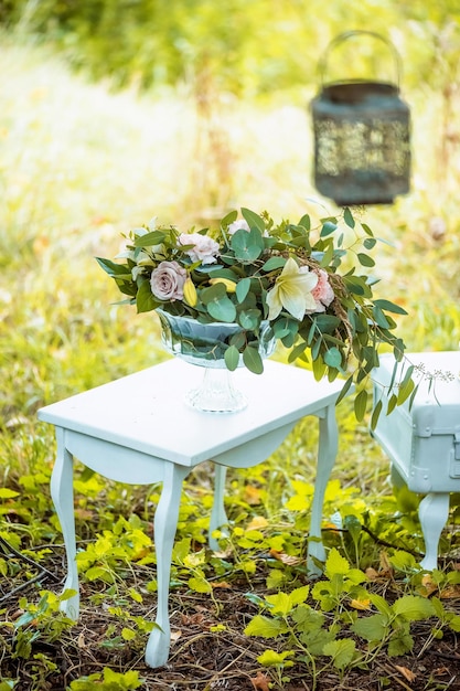 The decor for the wedding photo shoot table bent legs floral arrangement in a clear vase