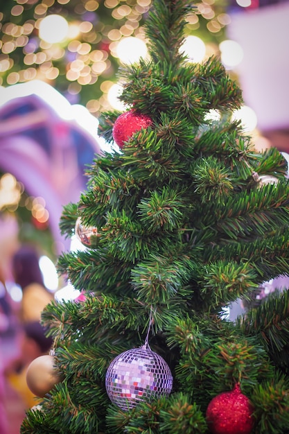 Decorate Christmas tree on blurry, sparkling and bokeh background.