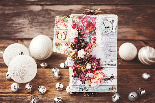 Decorated christmas gift box on old wooden background toned soft focus selective focus