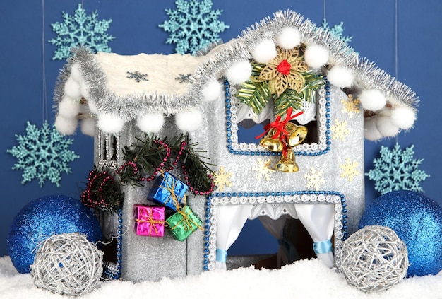 Decorated Christmas house on blue background