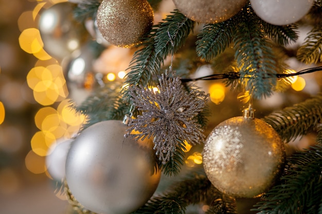 Decorated Christmas tree on blurred, sparkling and fairy background.