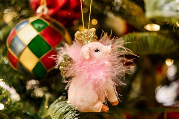 Decorated Christmas tree Christmas Eve christmas decorations new year Christmas tree toy in the form of a pink pig Selective focus Blurred background