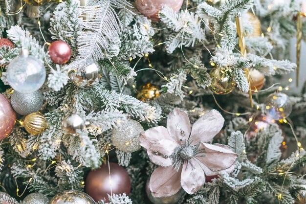 Decorated Christmas tree in golden and white toys with the lights bokeh textured background