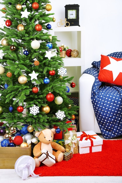 Decorated Christmas tree on home interior background