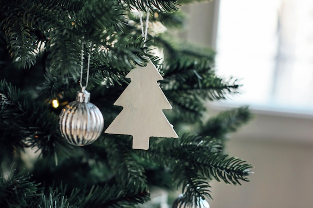 Decorated Christmas tree, minimalist Scandinavian decor backgrou