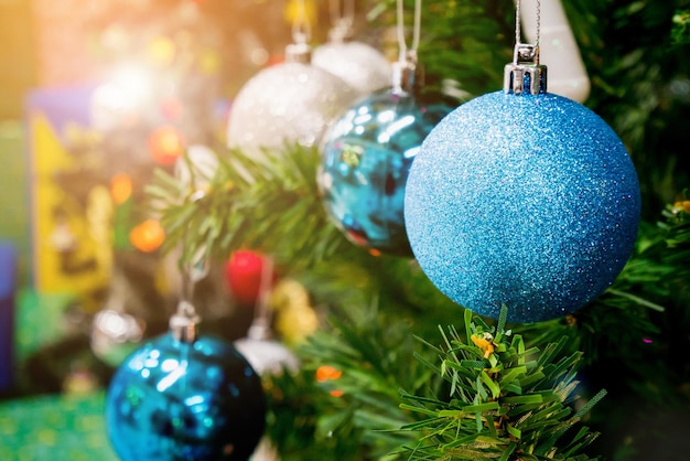 Decorated Christmas tree with colorful bauble on sparkling bokeh light blurred background