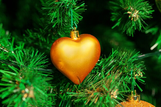 Decorated Christmas tree with heart-shape Christmas ball