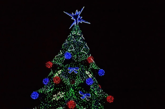 Decorated Christmas tree with multi-colored lights at night