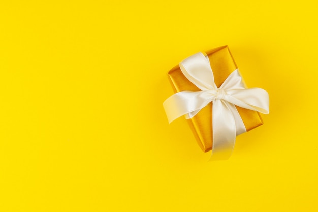 Decorated colored present on yellow surface