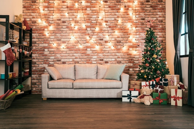 decorated cozy house with nobody indoor. living room ready prepared for coming up christmas and new year. presents and gift boxes under the xmas tree.