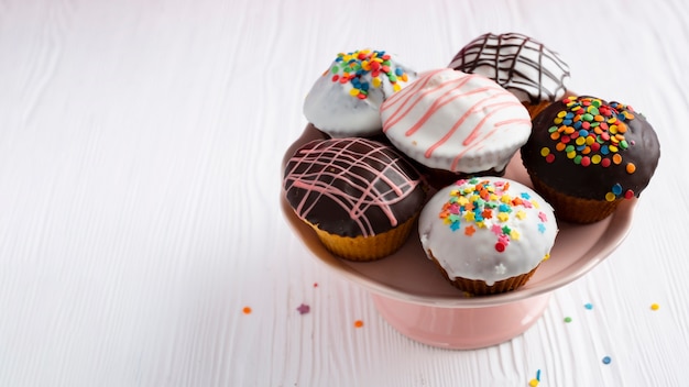 Photo decorated cupcakes on white table