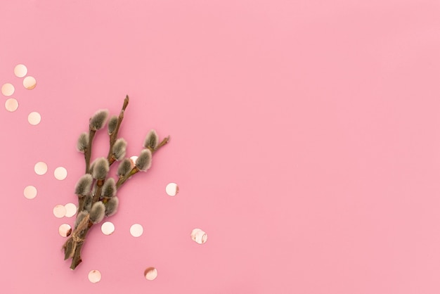 Decorated easter egg with party streamers on pink background. Easter concept. Flat lay.