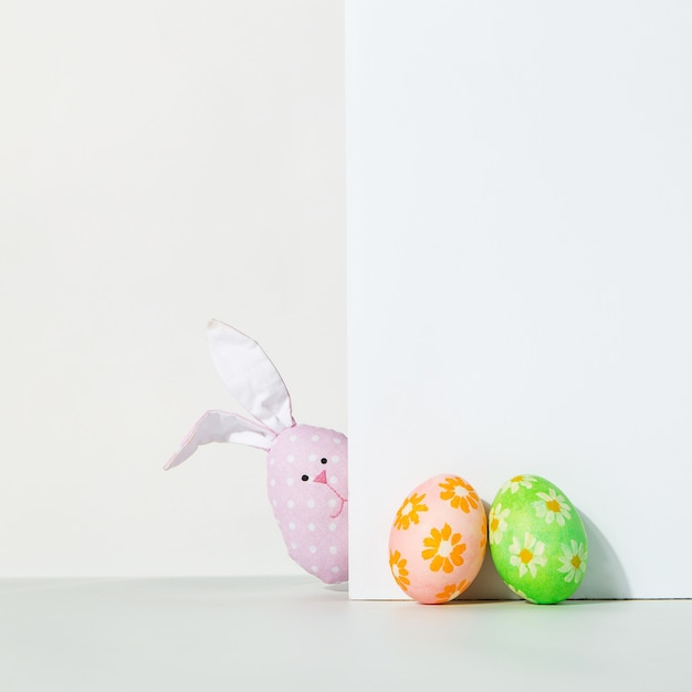 Decorated Easter eggs and rabbit on a white.