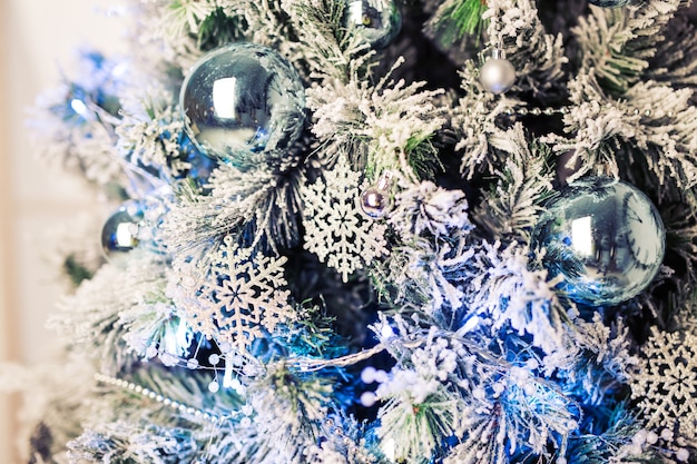 Decorated fir tree and gift boxes in living room.