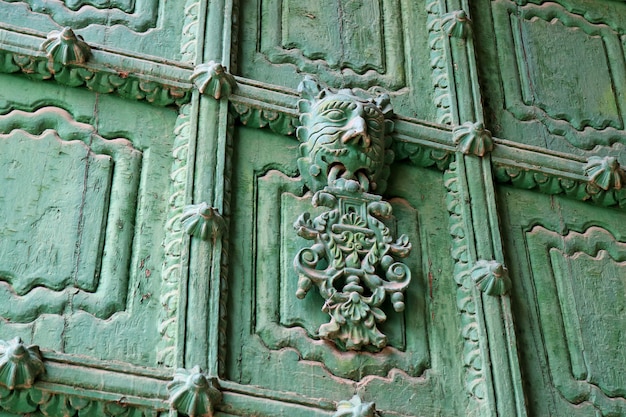 Decorated green front door of Puno Cathedral, Puno, Peru