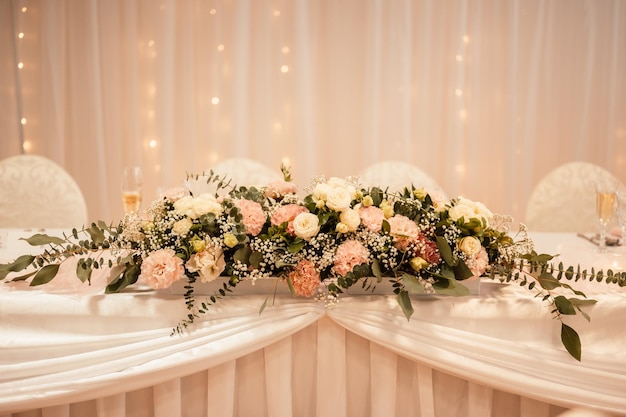 Decorated hall for wedding ceremony Wedding Banquet The chairs and round table for guests served with cutlery flowers