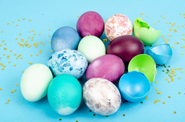 Decorated handmade Easter eggs for the holiday season on blue background. Creative minimal abstract  concept. Studio Photo