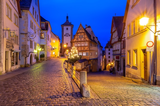 Decorated and illuminated Christmas street with gate and tower Plonlein in medieval Old Town of Rothenburg ob der Tauber, Bavaria, southern Germany