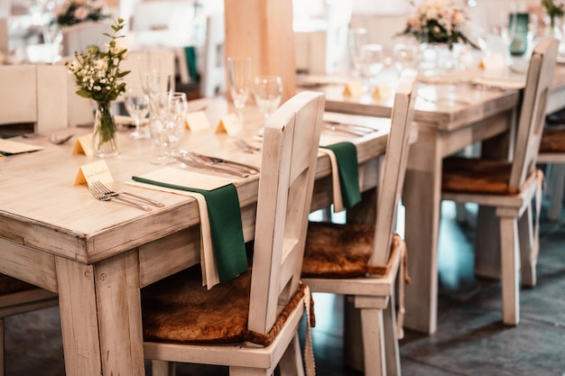 Decorated meadow for wedding ceremony Wedding Banquet The chairs and round table for guests served with cutlery flowers