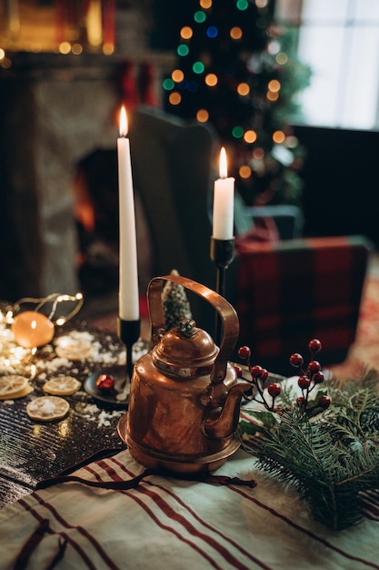 Photo decorated new years table with candles and antique teapot