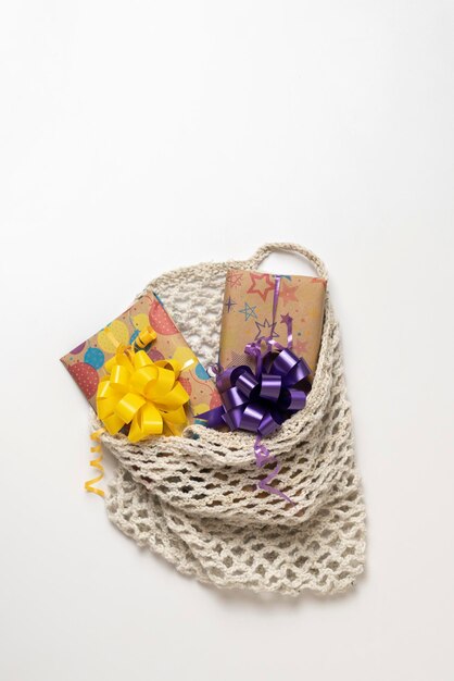 The decorated present box in the textile cotton mesh bag, reusable concept, give present to planet