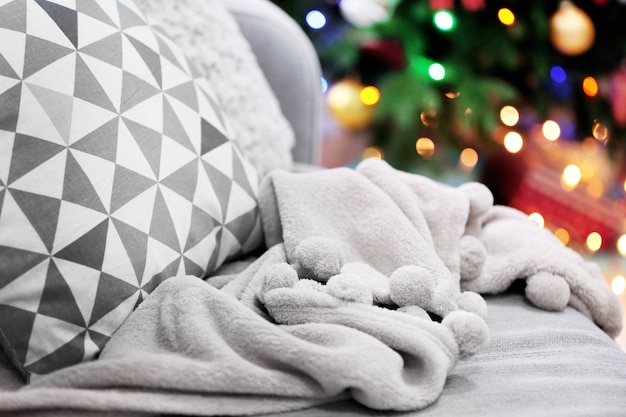 Decorated room with Christmas tree and sofa, close up, blurred