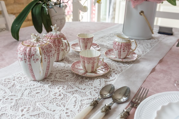 Decorated table for dinner with cups and spoon