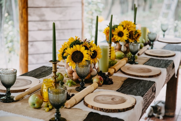 Decorated table for a rural themed party with sunflowers and fruits