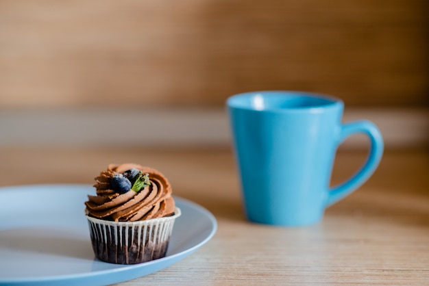 Decorated  tasty Cupcake with slice of Strawberry and Chocolate on the table. 