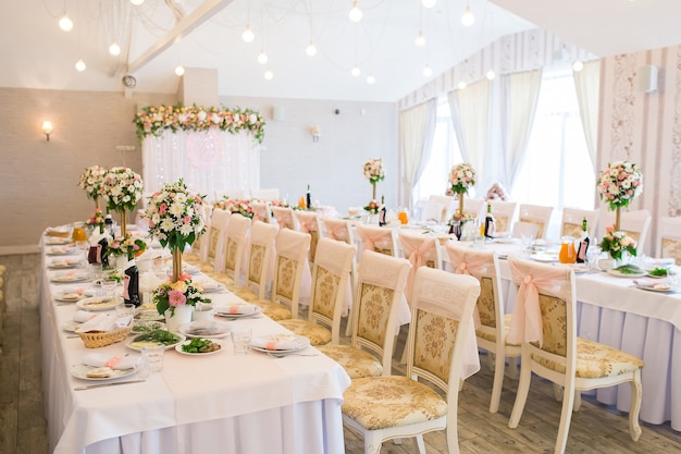 Decorated wedding banquet hall with served tables