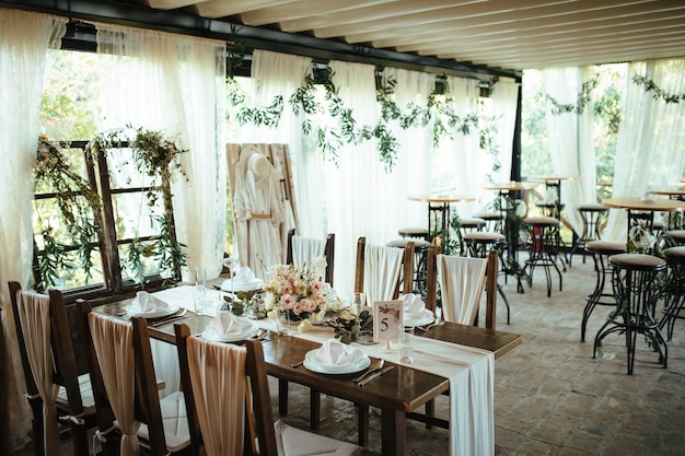 Decorated wedding reception hall with rustic table setting.