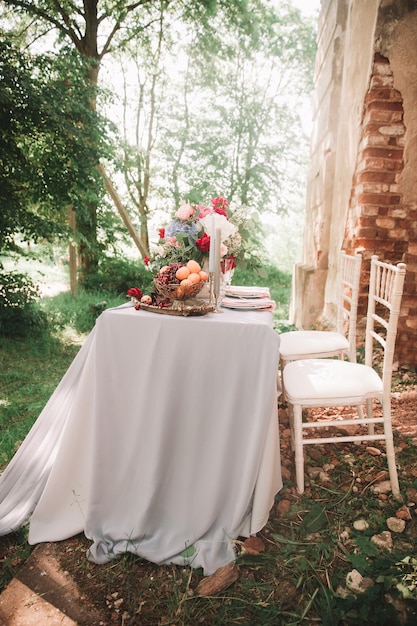 Decorated wedding table with candles in the garden